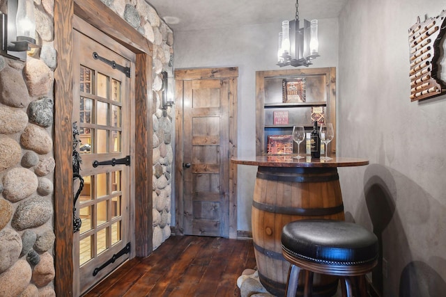 9328 Rhoy Ave, Chaska, MN 55318 - bar featuring dark wood finished floors and a chandelier