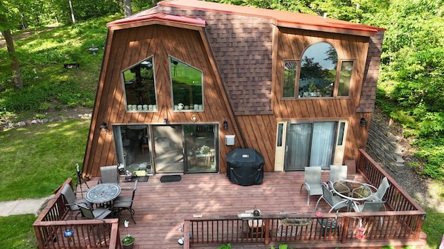 256 22 5/8 Ave, Crystal Lake Twp, WI 54829 - rear view of property with outdoor dining area, a deck, a shingled roof, and a lawn