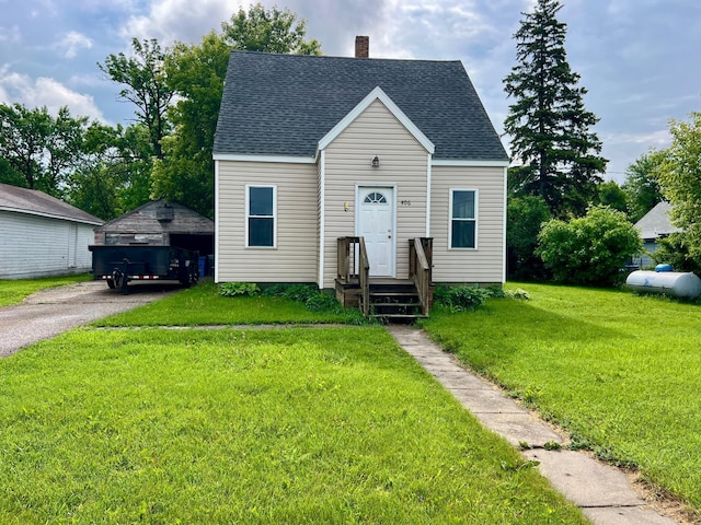 406 1st St S, Hoffman, MN 56339 - view of front of home featuring a chimney, a front lawn, an outdoor structure, roof with shingles, and a detached garage