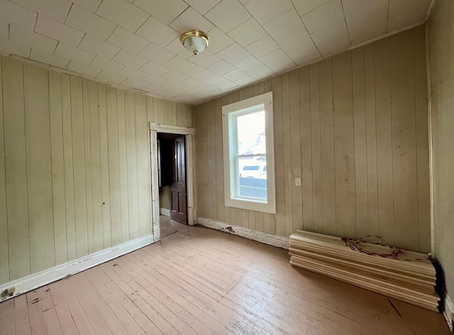 406 1st St S, Hoffman, MN 56339 - unfurnished bedroom with hardwood / wood-style floors, wood walls, and baseboards