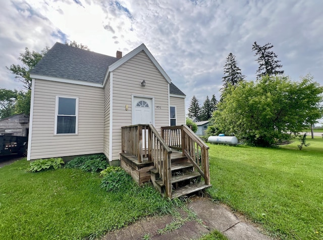 406 1st St S, Hoffman, MN 56339 - view of front of property featuring a chimney, a front yard, and a shingled roof