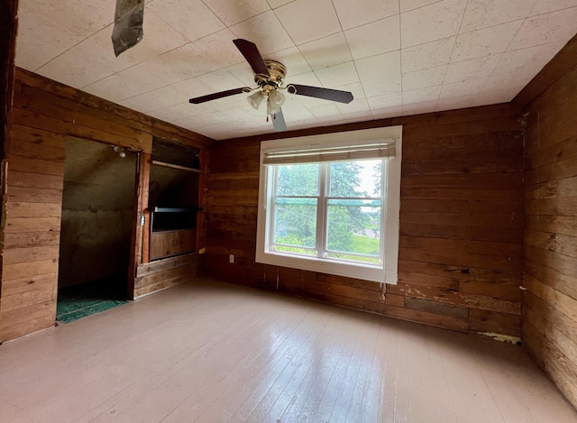 406 1st St S, Hoffman, MN 56339 - spare room with wooden walls, wood-type flooring, and a ceiling fan