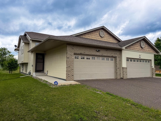922 Whiskey Rd NW, Isanti, MN 55040 - view of front of house featuring asphalt driveway, a garage, brick siding, a front lawn, and roof with shingles