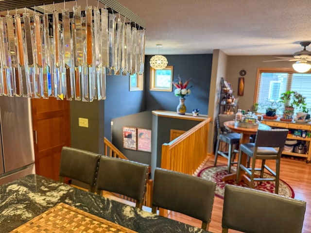 922 Whiskey Rd NW, Isanti, MN 55040 - bar area featuring plenty of natural light, ceiling fan, and wood finished floors