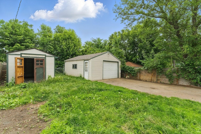 363 Geranium Ave E, Saint Paul, MN 55130 - view of yard with a garage, an outdoor structure, concrete driveway, and view of wooded area