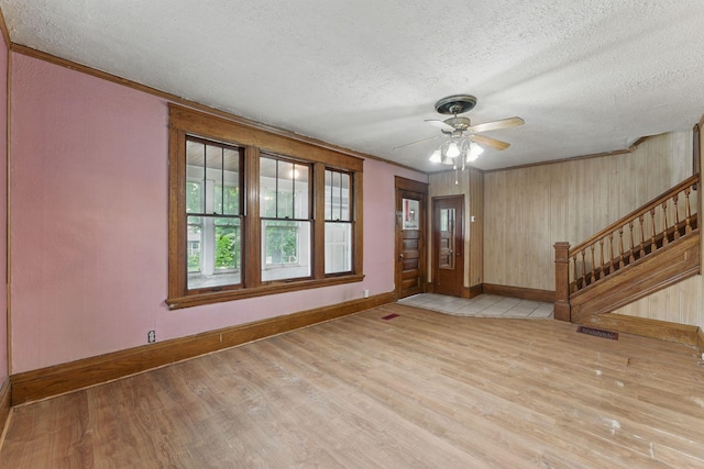 363 Geranium Ave E, Saint Paul, MN 55130 - foyer entrance featuring baseboards, a textured ceiling, wood finished floors, stairway, and ceiling fan