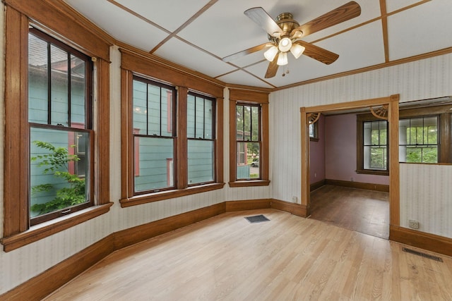 363 Geranium Ave E, Saint Paul, MN 55130 - unfurnished room with wallpapered walls, wood finished floors, baseboards, healthy amount of natural light, and crown molding