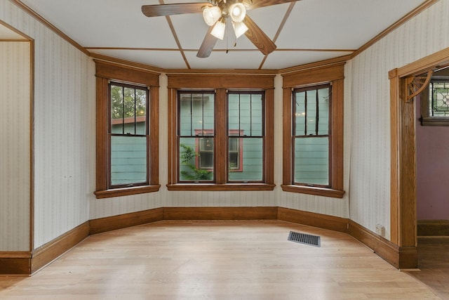 363 Geranium Ave E, Saint Paul, MN 55130 - empty room with light wood finished floors, crown molding, healthy amount of natural light, and ceiling fan