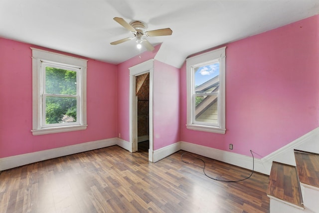 363 Geranium Ave E, Saint Paul, MN 55130 - unfurnished bedroom with multiple windows, wood finished floors, baseboards, and vaulted ceiling