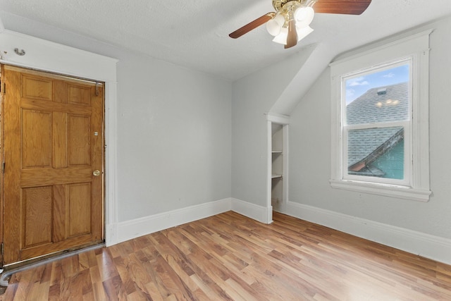 363 Geranium Ave E, Saint Paul, MN 55130 - unfurnished room featuring light wood-style flooring, baseboards, a ceiling fan, and vaulted ceiling