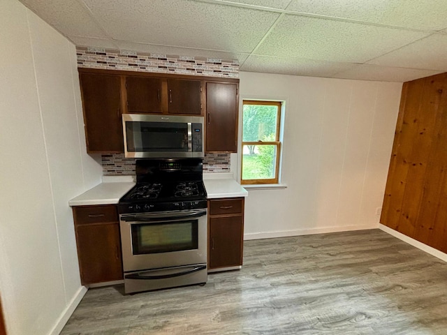 1116 Whitford St, Fergus Falls, MN 56537 - kitchen with stainless steel appliances, light wood-style floors, light countertops, decorative backsplash, and a drop ceiling