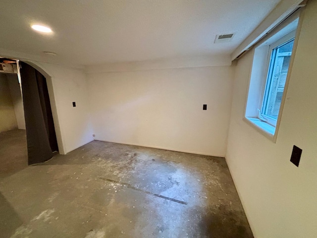 1116 Whitford St, Fergus Falls, MN 56537 - spare room featuring unfinished concrete flooring and arched walkways