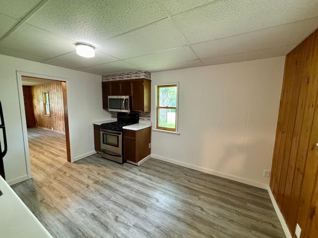 1116 Whitford St, Fergus Falls, MN 56537 - kitchen with stainless steel appliances, a paneled ceiling, light wood-style floors, and light countertops