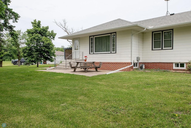 5555 167th Ave SE, Walcott, ND 58051 - back of house featuring a lawn, a patio, and roof with shingles