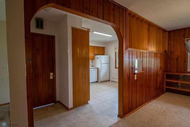 5555 167th Ave SE, Walcott, ND 58051 - corridor featuring arched walkways, a baseboard radiator, baseboards, and wooden walls