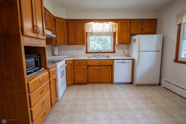 5555 167th Ave SE, Walcott, ND 58051 - kitchen with white appliances, a sink, under cabinet range hood, light countertops, and brown cabinetry