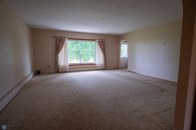 5555 167th Ave SE, Walcott, ND 58051 - empty room with arched walkways, light carpet, baseboard heating, and baseboards