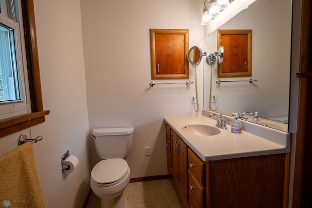 5555 167th Ave SE, Walcott, ND 58051 - bathroom featuring vanity, toilet, baseboards, and tile patterned floors