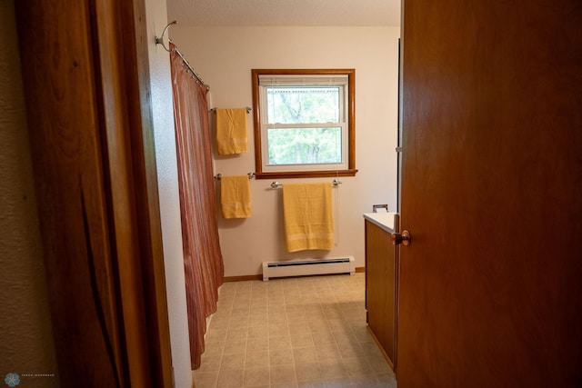 5555 167th Ave SE, Walcott, ND 58051 - bathroom with a baseboard radiator, tile patterned floors, baseboards, and curtained shower