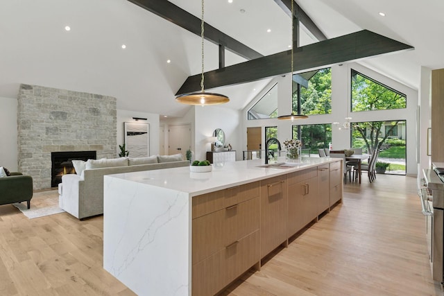 6608 Pawnee Rd, Edina, MN 55439 - kitchen featuring high vaulted ceiling, modern cabinets, beam ceiling, light brown cabinetry, and a spacious island