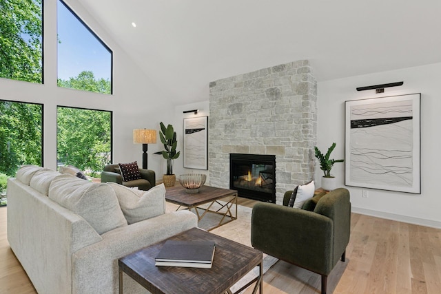 6608 Pawnee Rd, Edina, MN 55439 - living area with high vaulted ceiling, a stone fireplace, and light wood-type flooring