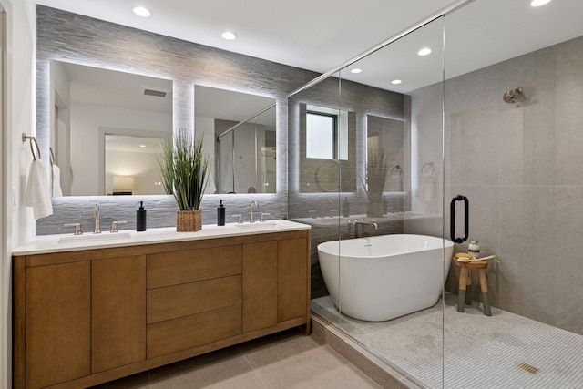 6608 Pawnee Rd, Edina, MN 55439 - full bathroom with tile walls, a freestanding tub, a stall shower, double vanity, and recessed lighting