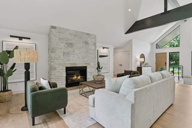 6608 Pawnee Rd, Edina, MN 55439 - living room with wood finished floors, a stone fireplace, and high vaulted ceiling