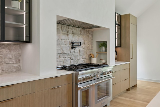 6608 Pawnee Rd, Edina, MN 55439 - kitchen featuring range with two ovens, tasteful backsplash, light countertops, and glass insert cabinets