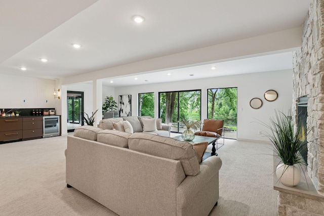 6608 Pawnee Rd, Edina, MN 55439 - living room featuring a dry bar, light colored carpet, a stone fireplace, wine cooler, and recessed lighting