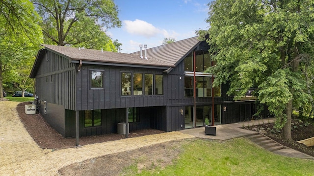 6608 Pawnee Rd, Edina, MN 55439 - back of house with a patio, a lawn, and board and batten siding