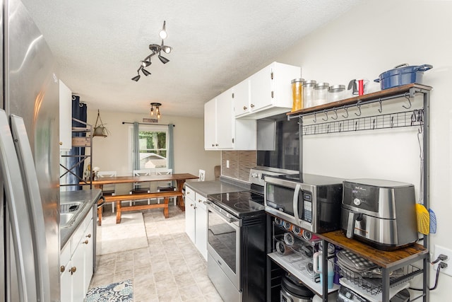 15326 11th St S, Afton, MN 55001 - kitchen featuring stainless steel appliances, white cabinetry, decorative backsplash, a textured ceiling, and rail lighting