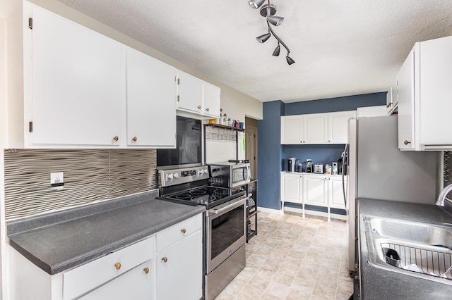 15326 11th St S, Afton, MN 55001 - kitchen featuring appliances with stainless steel finishes, a sink, white cabinetry, and dark countertops
