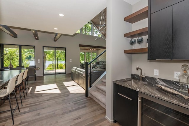 19923 See Gull Rd, Brainerd, MN 56401 - kitchen featuring open shelves, wine cooler, open floor plan, dark stone counters, and a sink