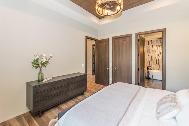 19923 See Gull Rd, Brainerd, MN 56401 - bedroom with a tray ceiling, a chandelier, wood finished floors, wood ceiling, and baseboards
