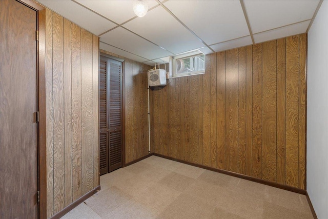 W7324 State Road 65, Trimbelle, WI 54003 - below grade area featuring wood walls, carpet, a drop ceiling, and a wall mounted air conditioner