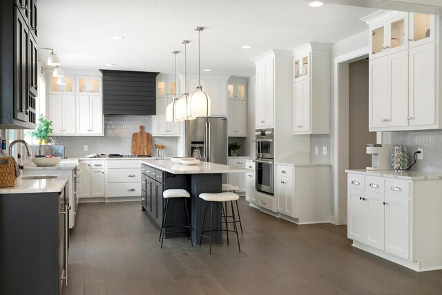 6501 Timber Arch Dr, Chaska, MN 55318 - kitchen featuring a sink, a kitchen bar, stainless steel appliances, tasteful backsplash, and recessed lighting