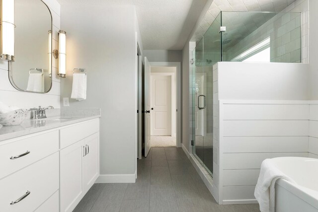 6501 Timber Arch Dr, Chaska, MN 55318 - full bath with vanity, a stall shower, a tub to relax in, and baseboards