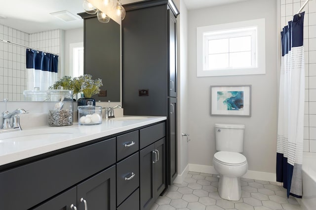 6501 Timber Arch Dr, Chaska, MN 55318 - bathroom featuring double vanity, toilet, tile patterned floors, baseboards, and shower / bath combo