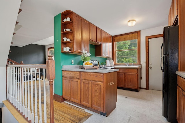 3015 22nd St, Minneapolis, MN 55406 - kitchen featuring freestanding refrigerator, open shelves, light countertops, light floors, and brown cabinetry