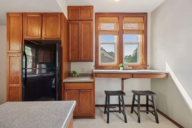3015 22nd St, Minneapolis, MN 55406 - kitchen with freestanding refrigerator and brown cabinetry