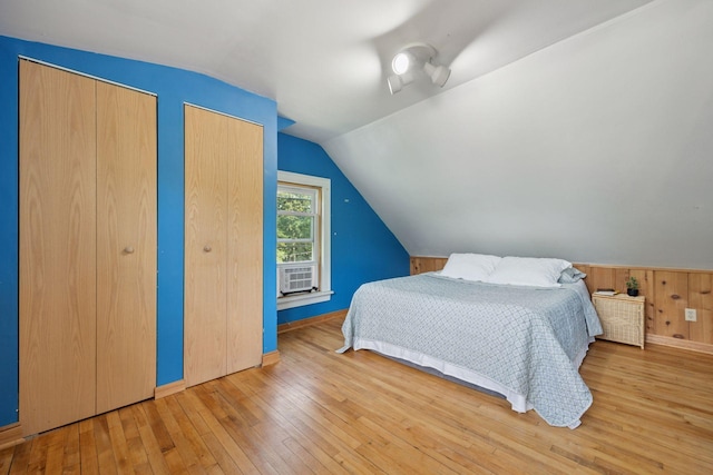 3015 22nd St, Minneapolis, MN 55406 - bedroom featuring multiple closets, lofted ceiling, and hardwood / wood-style floors