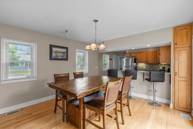 2800 Alabama Ave S, Saint Louis Park, MN 55416 - dining space with a chandelier, light wood-type flooring, healthy amount of natural light, and baseboards