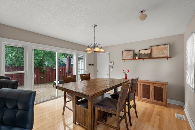 2800 Alabama Ave S, Saint Louis Park, MN 55416 - dining room with a chandelier, light wood-style floors, a textured ceiling, and baseboards
