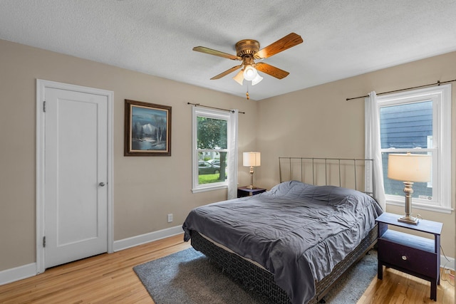 2800 Alabama Ave S, Saint Louis Park, MN 55416 - bedroom with light wood-type flooring, baseboards, a textured ceiling, and ceiling fan