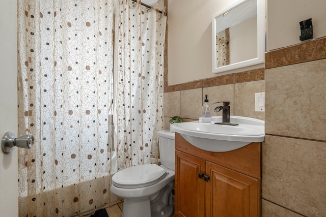 2800 Alabama Ave S, Saint Louis Park, MN 55416 - bathroom with vanity, tile walls, toilet, shower / bath combo, and a wainscoted wall