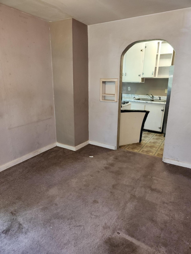 1816 Malvern St, Lauderdale, MN 55113 - spare room featuring a sink, light carpet, arched walkways, and baseboards