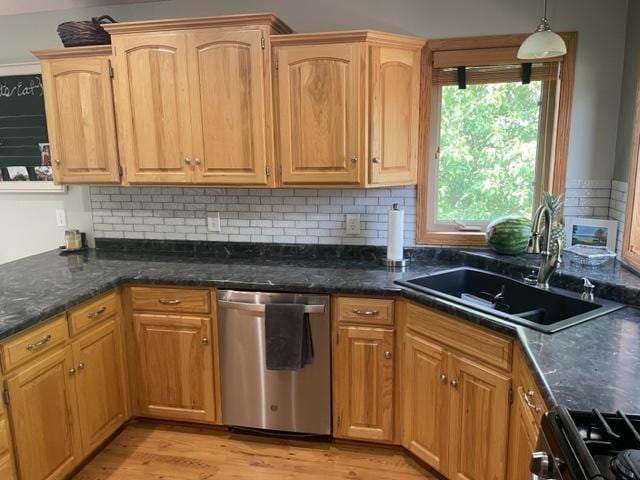 409 Iris Ln NE, Saint Joseph, MN 56374 - kitchen featuring stainless steel dishwasher, a sink, gas range oven, light wood-type flooring, and decorative backsplash