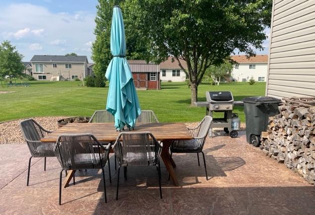 409 Iris Ln NE, Saint Joseph, MN 56374 - view of patio / terrace featuring outdoor dining area, a grill, and an outdoor structure