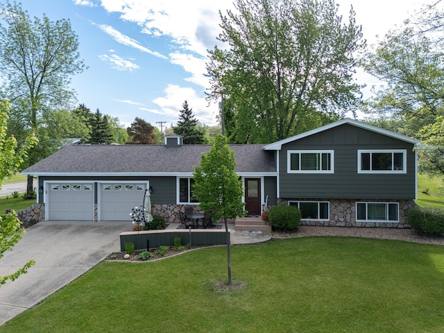 701 Mill St, Fertile, MN 56540 - tri-level home featuring a garage, driveway, a front lawn, stone siding, and roof with shingles