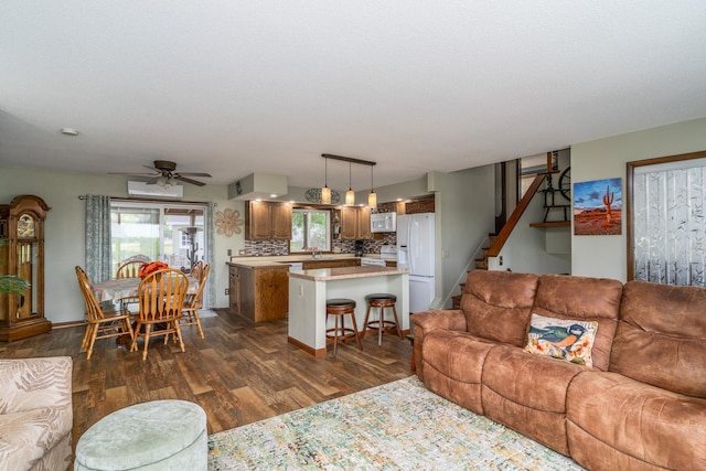 701 Mill St, Fertile, MN 56540 - living room featuring dark wood finished floors, stairs, ceiling fan, and baseboards